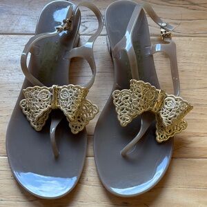 Salvatore Ferragamo Taupe Jelly Sandals with Gold Lace Bow